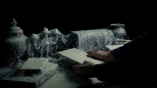 Someone Takes Old Book Off Table Covered With Cobwebs