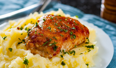 Roasted chicken breast roll stuffed with chicken and pork meat with mashed potatoes in white plate on table