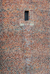 Old wall made of red brick with window