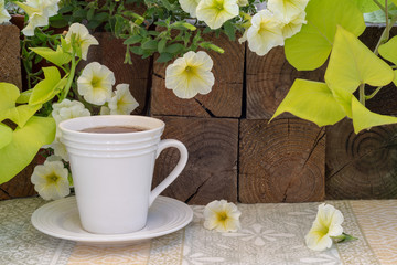 White Teacup in Garden on Peaceful Morning