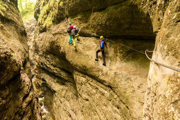 Climbing adventure in deep canyon of Postalmklamm via ferrata, Austria