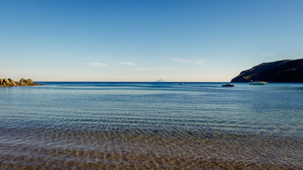 Looking at the island of Montecristo in Italy from the Laconella Beach on the Elba island. Taken on a beautiful tranquil morning in the spring.