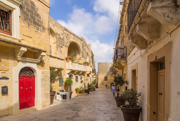 Fototapeta na wymiar Victoria, the island of Gozo, Malta. Old Narrow street (Triq id-Dejqa)