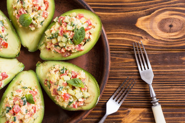 Avocado stuffed with cucumber , tomatoes and eggs