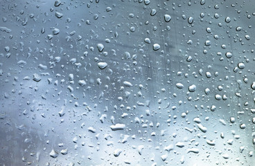 Drops on glass against the sky