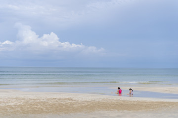 Children playing on the beach near the sea
