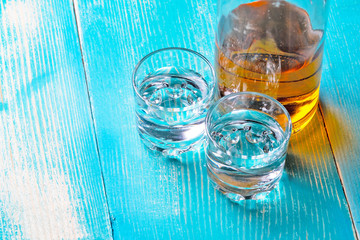 the bottle of rum on the blue table there are two