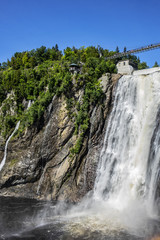 The Montmorency waterfall and bridge over waterfall. Montmorency falls, located between the river and the cliffs (10 km east of Quebec City): 275 feet (83 meters) high. Quebec, Canada, North America.