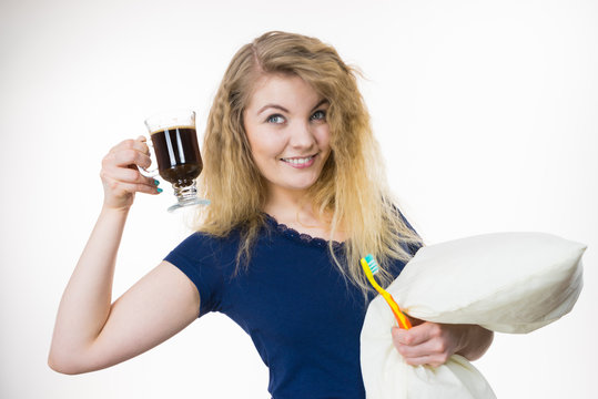 Happy woman holding toothbrush and coffee