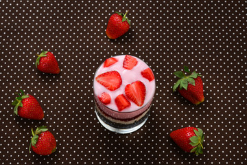 Home made granola breakfast with strawberries and plain yogurt, served in the glass.