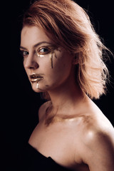 Fototapeta premium collagen gold mask. collagen treatment for woman with golden face. golden collagen makeup for sexy woman isolated on black. collagen mask in spa salon for skincare. Luxury tanning and skin care