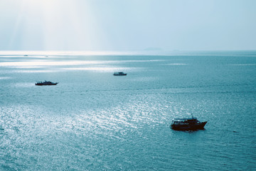 Boats on shiny sea