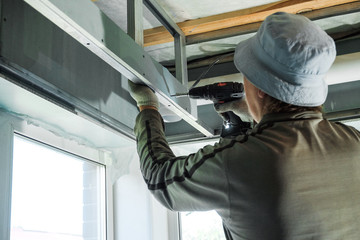 worker making repairs in a country house