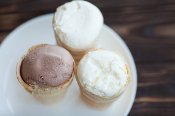 Vanilla ice cream in waffle cup isolated on wooden background. Summer concept.