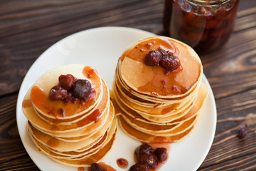 Pancakes with strawberry jam for a breakfast.