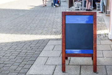 Forefront of a Poster placed on the ground of a pedestrian street in England