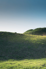 panoramic view of nice green hills with grass and walk path