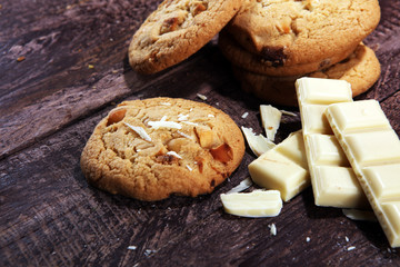 stack of macadamia nut and white chocolate cookies on table with chocolate chip