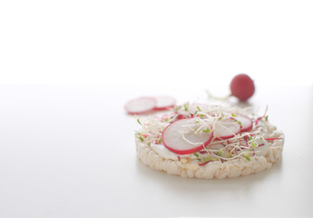 Healthy snack concept Rice bread Crispy bred Radish slices Sprouts Marrow slices Cottage cheese High key Copy space