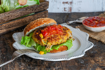 Tuna and sweetcorn burger with tomato salsa in a bun