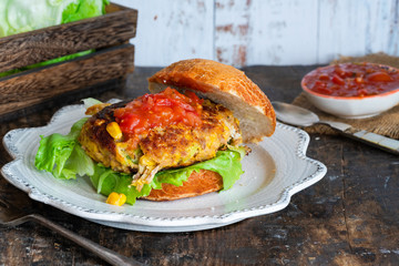Tuna and sweetcorn burger with tomato salsa in a bun