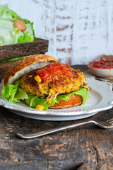 Tuna and sweetcorn burger with tomato salsa in a bun