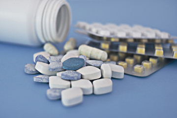 Supplements and medications, a pill bottle and blister packs, close-up