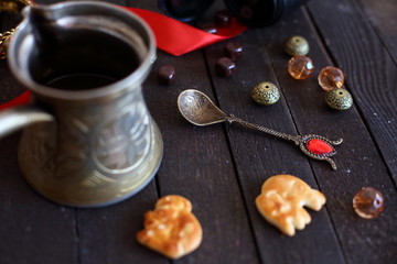 coffee cookies and chocolate on dark wooden background