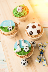 Football party, birthday decorated cupcake on green grass