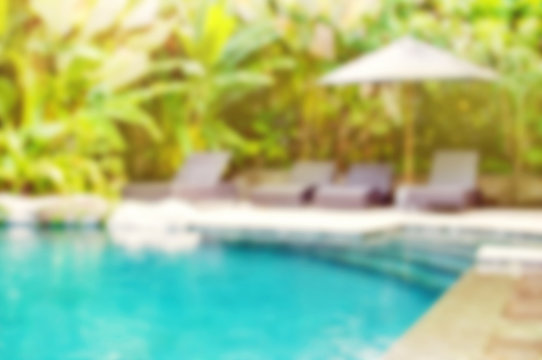 Abstract Blur Outdoor Swimming Pool Background. Blur Summer Background For Resort Hotel Pool Party And Tropical Palm Tree