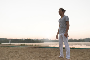 Athletic capoeira performer resting after training on the beach