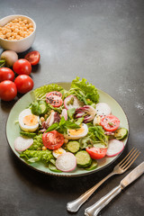 Salad from fresh vegetables and eggs for proper nutrition. Summer food.