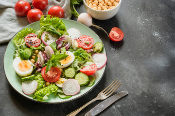 Salad from fresh vegetables and eggs for proper nutrition. Summer food.