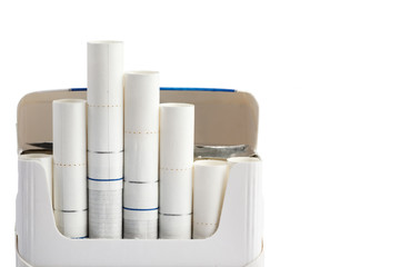 Cigarettes with white filter in a pack, isolated on white background. Close-up.