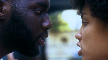 Young couple quarreling suspicious jealous wife provoking conflict, face closeup