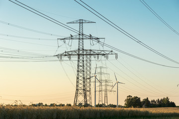 high voltage power line with pylon at a agricultural field