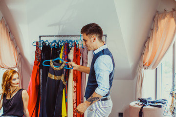 Male shop assistant and young woman in the fashion boutique
