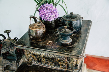 Old vintage kitchen with pots and teapots with flowers, concept of decoration