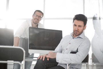 confident businessman sitting at a computer table