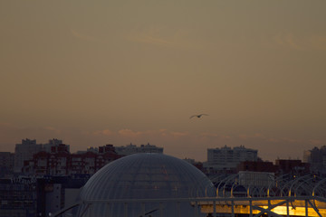 Obraz premium Sunset over the city. Twilight and buildings landscape. Bright sunset over the horizon