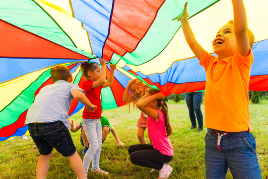 Close up view of children under the huge rainbow cover