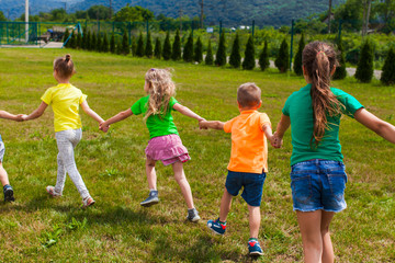 Group of children in colorful t-shirts on their holidays