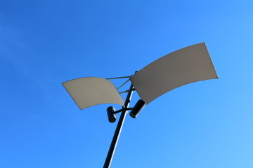 Modern LED lamp post with two reflecting panels and two LED lamps pointed at them