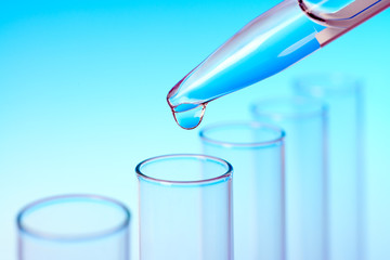 Drop from pipette falling in a tube, text space