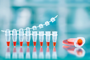 DNA amplification test and reaction mixture in larger tube on the side, text space