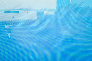 Blue water in vibrant swimming pool, rippled light serene turquoise idyllic background