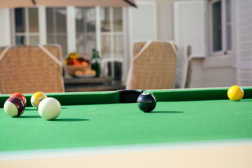 Closeup on billiard balls on green pool table entertainment background