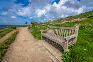 Naklejka na ściany i meble Empty bench on Cornish coast
