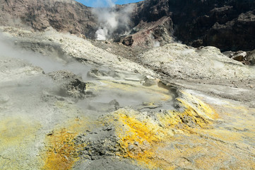 Thermal activity in the crater of the active volcano of White Island, Whakaari, off the Bay of Plenty coast, New Zealand. Yellow crystals of sulphur in the foreground.
