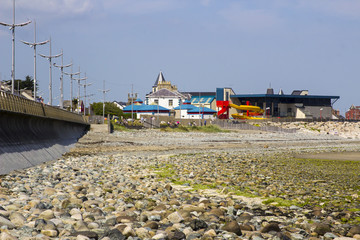The pebble beach beneath the new Promenade breakwater at Newcastle in County Down Northern Ireland on a hot summer day.